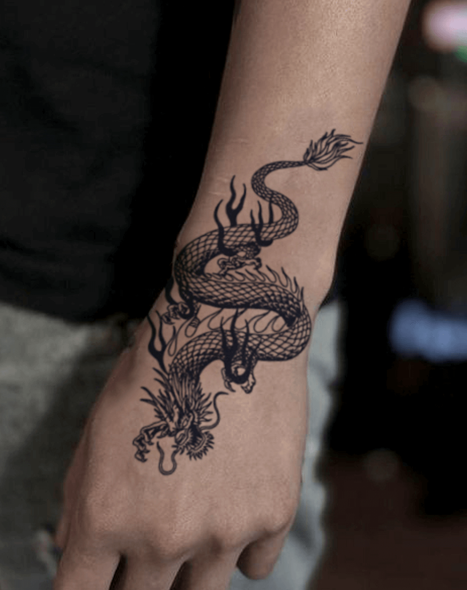 Stylish Inferno Dragon temporary tattoo art on a man's forearm for cool body decoration.
